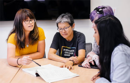 Mentor helping students with paperwork