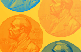 close-up of Nobel medals against a yellow background
